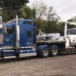 Vehicle transport on an open deck trailer